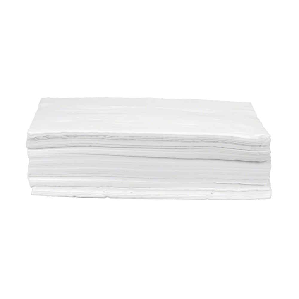 A stack of absorbent B. Braun Askina® Cel dressing cellulose unbleached napkins lies on a plain white background. These white napkins, used like dressing cellulose in wound care, are neatly stacked on top of each other, making their many layers visible.