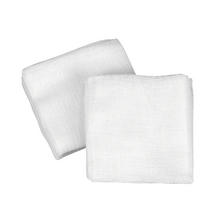 On a white background, there are two unused B. Braun Askina gauze compresses, manufactured by B. Braun Deutschland GmbH & Co. KG, depicted, which are ideal for effective wound care due to their textured and folded surface.