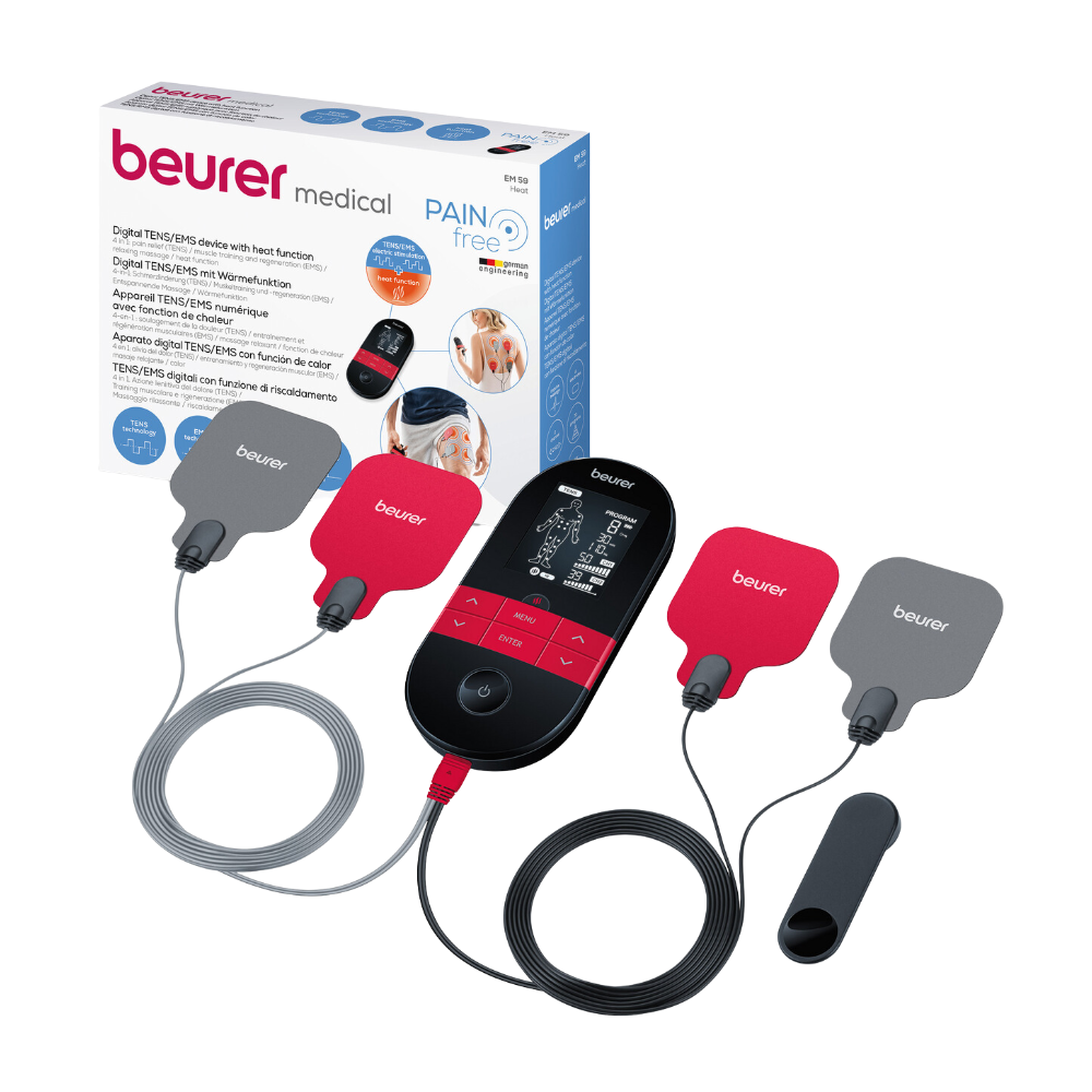 The image shows a Beurer Digital TENS/EMS EM 59 with heat function device from Beurer GmbH. The device features a large display with wires connected to four electrodes, two of which are red and two are gray. In the background, the packaging box with the inscription "Beurer Digital TENS/EMS EM 59 with heat function | Package (1 piece)" can also be seen.