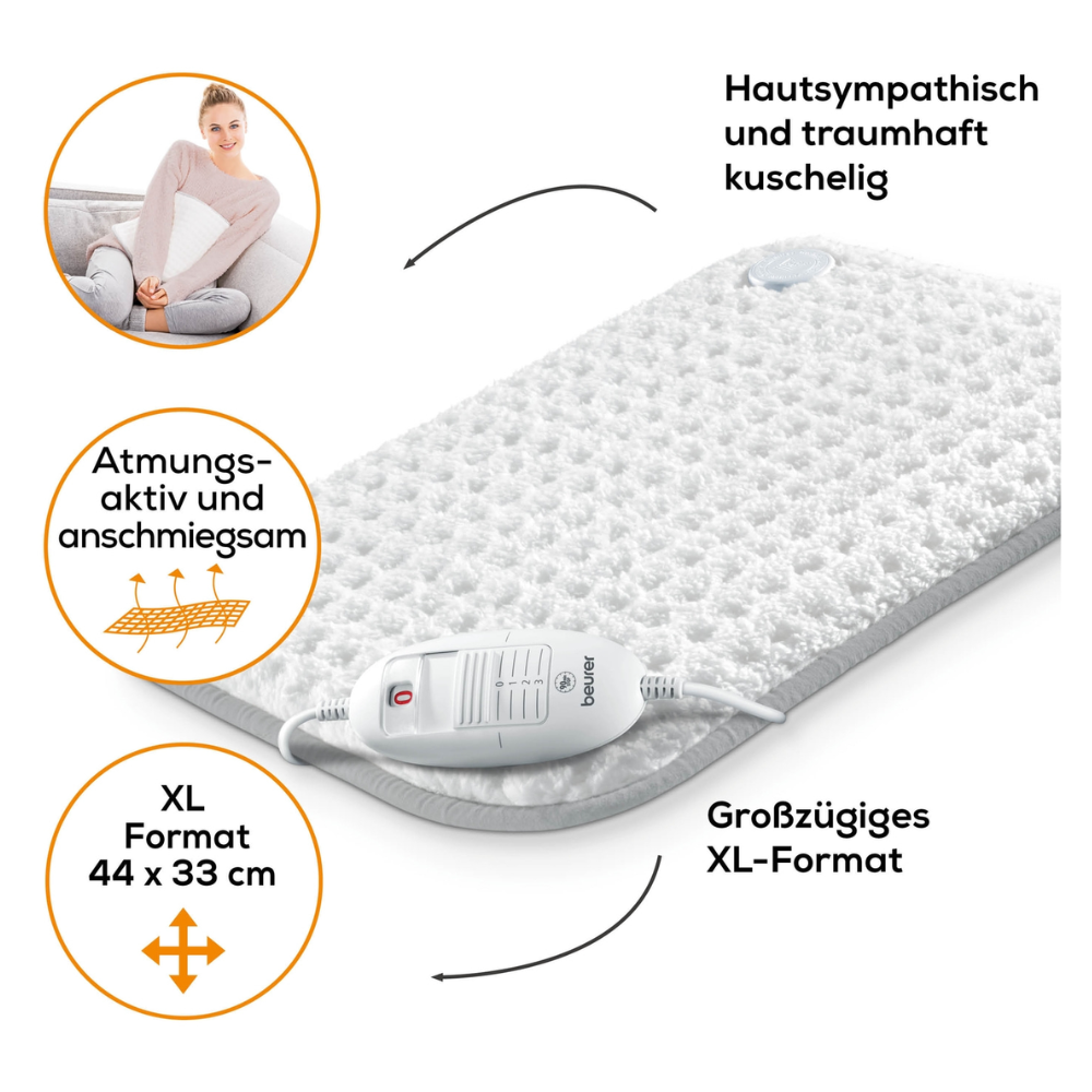 The Beurer HK 42 Heating Pad Super-Cosy from the Beurer GmbH is a white heating pad with a textured surface and the inscription "Skin-friendly and wonderfully cozy," "Breathable and cuddly" (breathable and cuddly), and in the generous XL format of 44 x 33 cm.