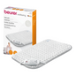 Next to the product, there is a Beurer HK 42 Heating Pad Super-Cosy from the Beurer GmbH with the brand "wellbeing" depicted on the packaging. The white pad with a gray border is equipped with a remote control. The packaging also shows an image of the heating pad in use and highlights the quick heating function.