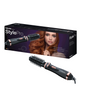 A Beurer HT 80 Rotating Hot Air Brush from Beurer GmbH is pictured in front of its packaging box. The box shows an image of a woman with styled hair and product details. The brush has a cylindrical design with bristles and an attached power cord.