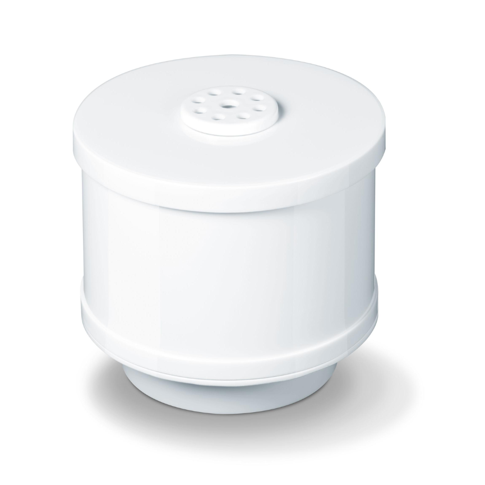 A cylindrical white Beurer LB 44, LB 45, LB 88 lime filter from Beurer GmbH lies on a white surface. The filter has a perforated top and a smooth exterior with a slightly wider base and top, creating a subtle bulge in the middle.