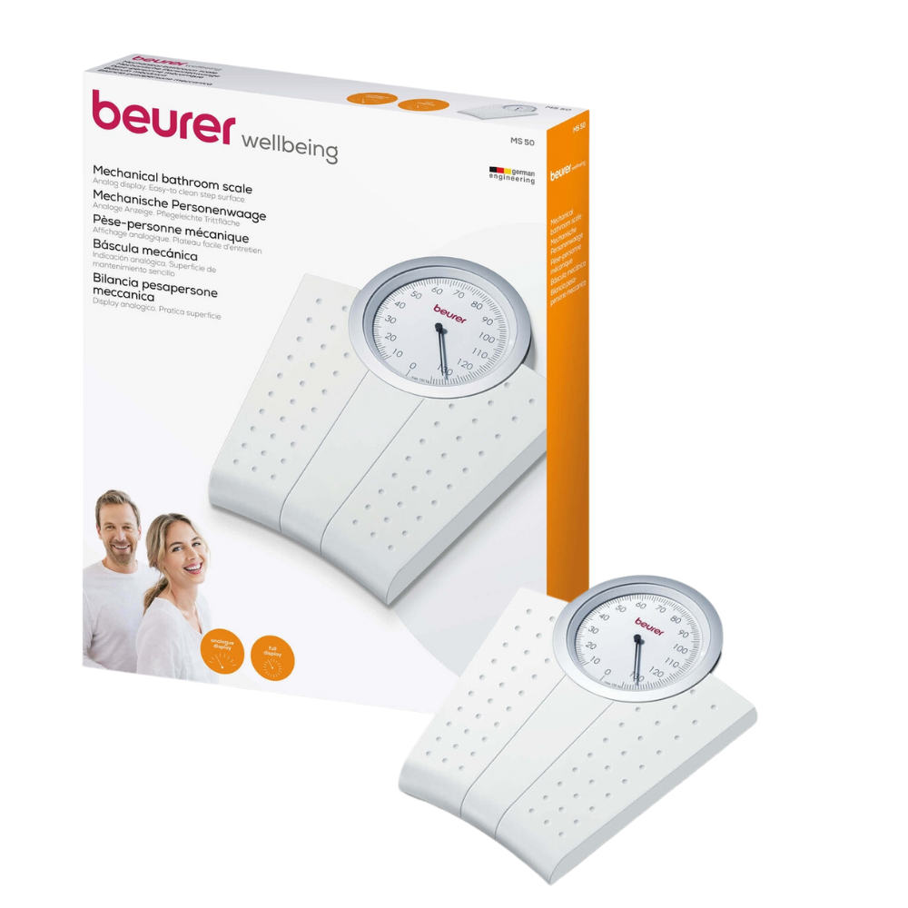 A photo showing a mechanical personal scale Beurer MS 50 | Package (1 piece) by Beurer GmbH with its packaging. The scale has a white, non-slip surface with a distinctive round, analog weight display on top. Next to the scale, the packaging box shows a picture of the scale and a picture of two smiling people.