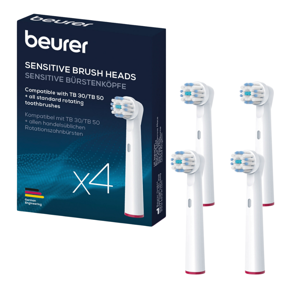 Pictured are a box and four individual Beurer Sensitive brush heads of Beurer GmbH. The blue box indicates that the brush heads are compatible with TB 30/TB 50 and all common rotating toothbrushes. The white brush heads feature blue bristles with a red ring at the base, additionally, a replacement set is available.