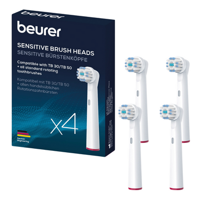 Pictured are a box and four individual Beurer Sensitive brush heads of Beurer GmbH. The blue box indicates that the brush heads are compatible with TB 30/TB 50 and all common rotating toothbrushes. The white brush heads feature blue bristles with a red ring at the base, additionally, a replacement set is available.
