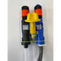 Two dosing injectors, one black and one blue with an orange tip, are connected by a green band and a yellow cap with a lower gray hose. Part of the QuattroSelect Manifold Air Gap Oxivir Excel JFill Systems from Diversey Deutschland GmbH & Co. OHG.