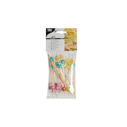 In a plastic package, there are 40 PAPSTAR finger food picks, each 12 cm long, with sustainable wooden skewers adorned with colorful cube-shaped decorations at one end. The skewers are manufactured by PAPSTAR GmbH and are perfect as a party snack. Brand and product information is visible on the packaging.
