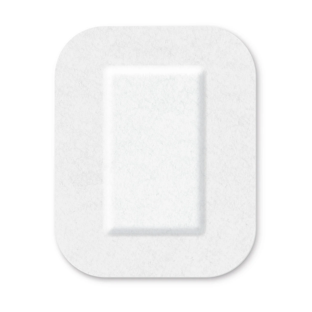 A white, square button with rounded edges and a slightly raised, rectangular center, equipped with a sterile adhesive layer of Cosmopor® silicone on a clear background by Paul Hartmann AG.