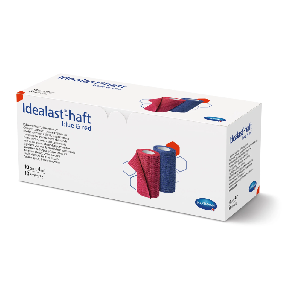 A box of Hartmann Idealast®-haft Color bandages in blue and red, shown from the side, with images and descriptions of the bandages on the packaging. The logo of Paul Hartmann AG is visible.