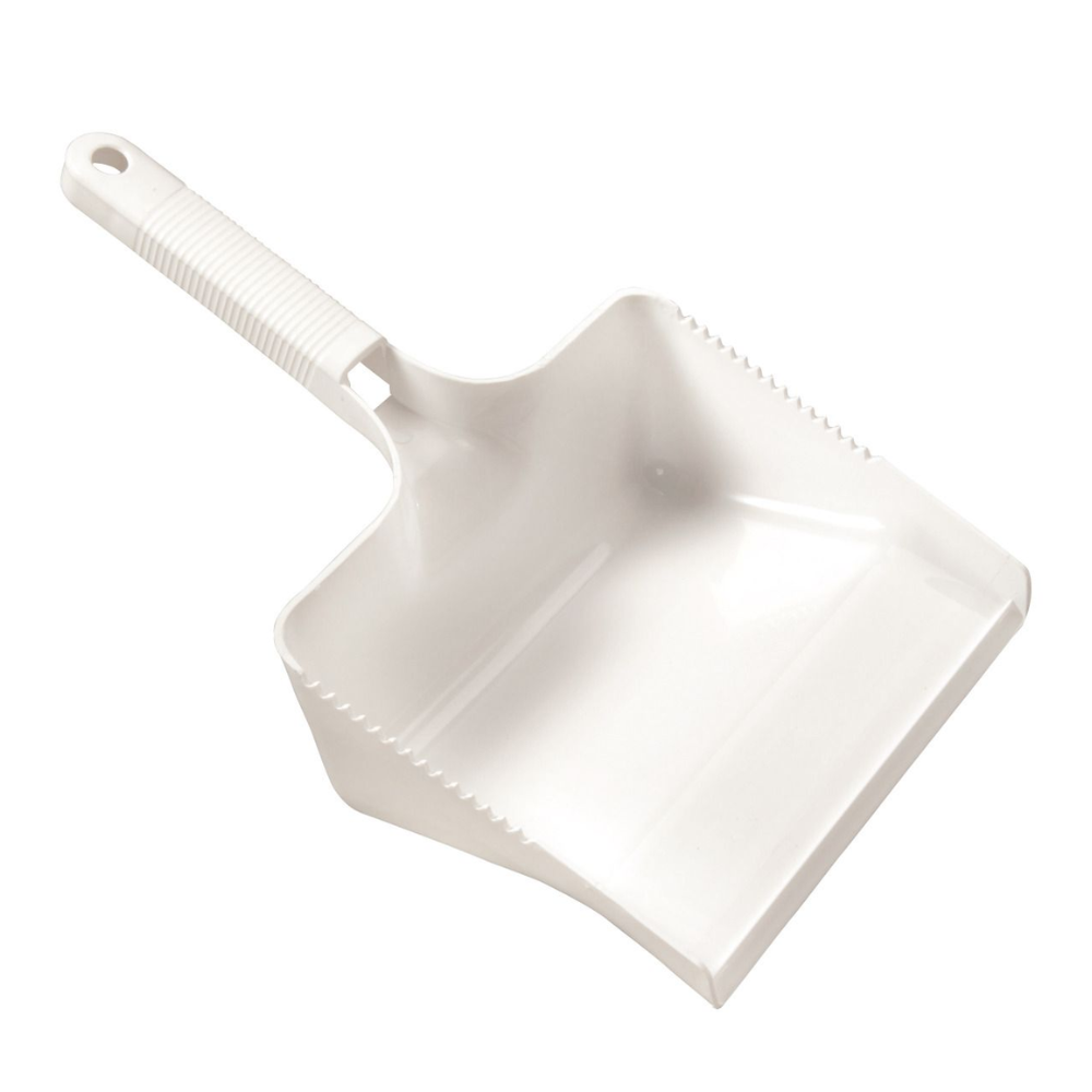A white dustpan from Haug Bürsten KG with a ribbed handle and slightly curved edge is positioned at an angle, making the open scoop and integrated broom comb visible. The handle features a convenient hanging hole for easy storage.