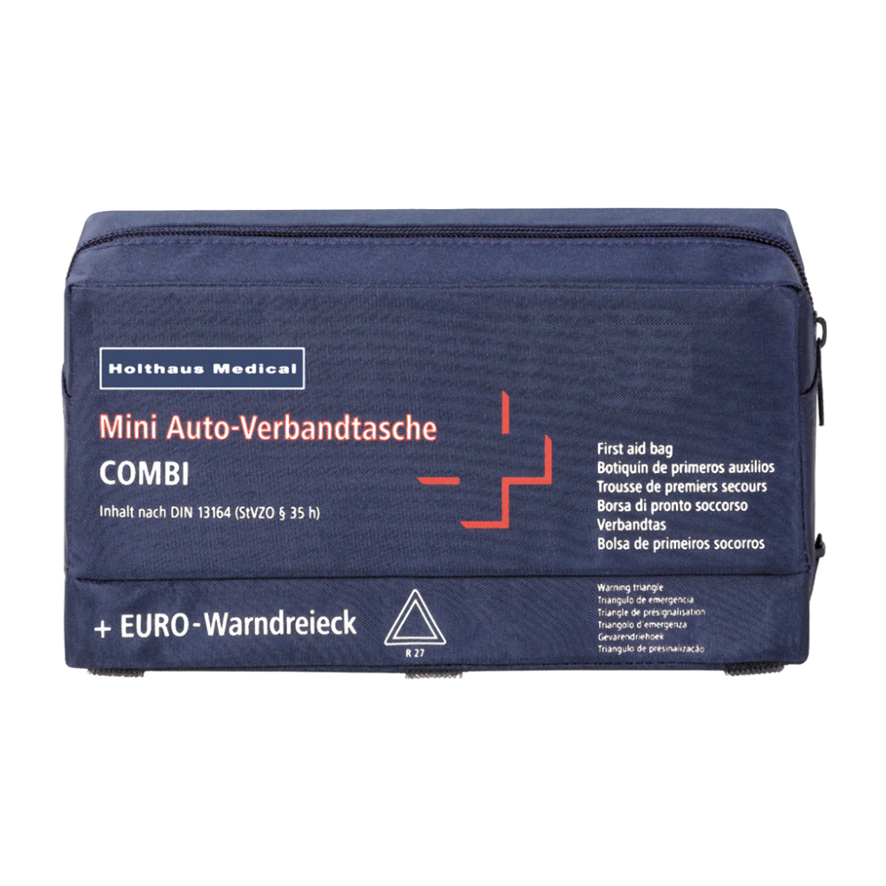 A navy blue first aid bag with the inscription “Holthaus Mini Combi Auto First Aid Bag” from Holthaus Medical GmbH & Co. KG, featuring a white cross and red details. The text includes several translations of “first aid bag” and mentions that the contents comply with the DIN 13164 standard.
