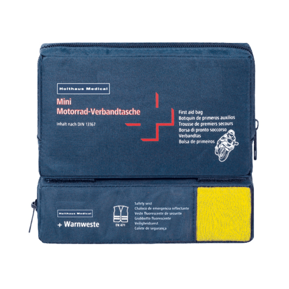 A blue first aid kit with the inscription "Holthaus Mini Combi Verbandtasche Motorrad" from Holthaus Medical GmbH & Co. KG with multilingual text for motorcycles. It complies with DIN 13167 and contains a high-visibility vest visible through a transparent section. The Mini Combi Verbandtasche features two zipper compartments – one on top and one on the side.