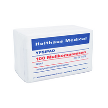 A rectangular package of Holthaus YPSIPAD gauze compress, 100 pieces, from Holthaus Medical GmbH & Co. KG, with German labeling indicating sterile gauze compresses for wound care. The packaging is white with blue and red text indicating size and standards.