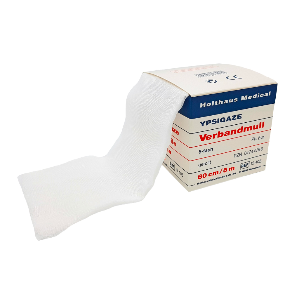 A pack of Holthaus Ypsigaze bandage gauze in various sizes from Holthaus Medical GmbH & Co. KG contains partially unrolled white gauze made of 100% cotton. The label indicates that the gauze is 80 cm wide and 5 meters long, with various product codes and specifications.