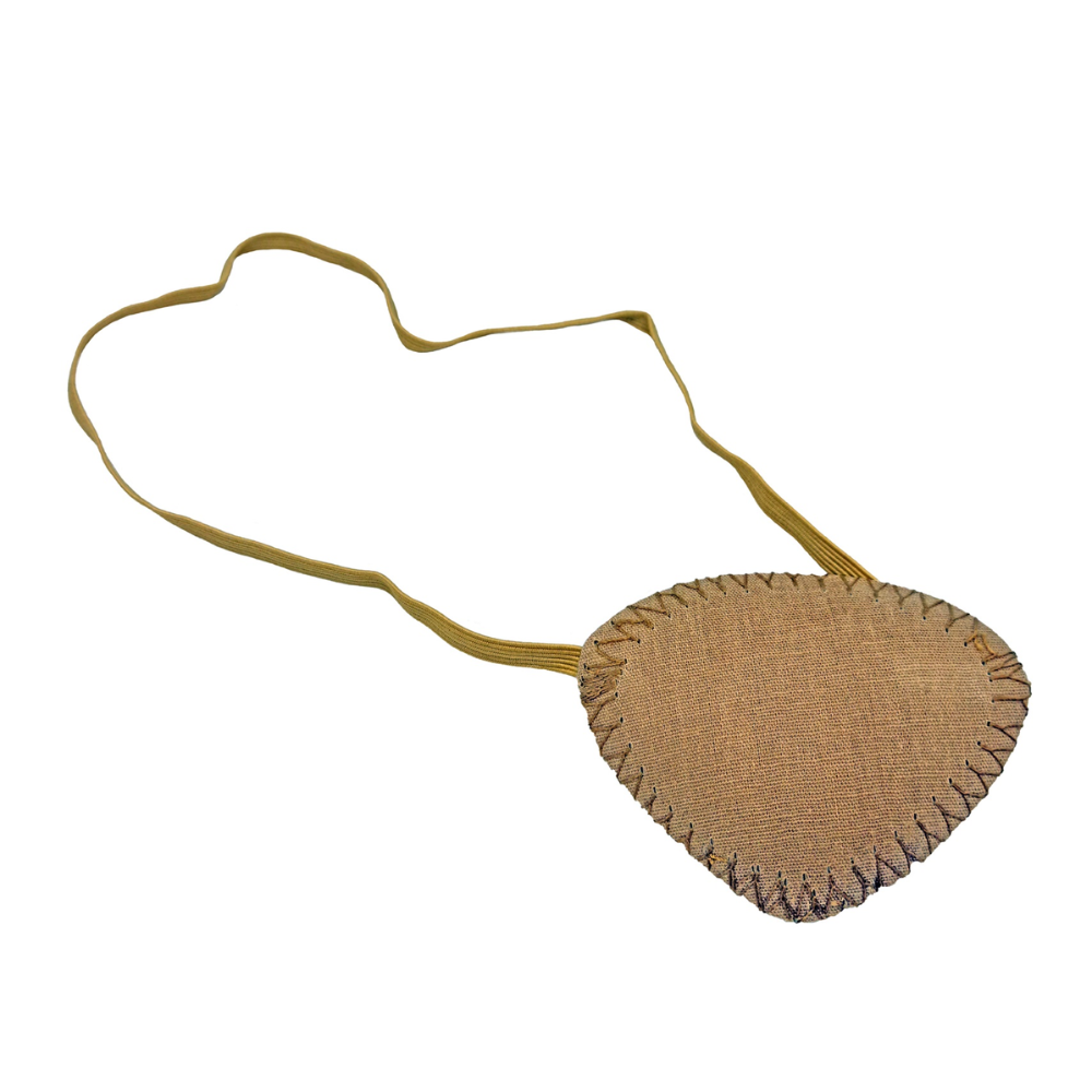 A heart-shaped pouch made of light brown fabric with visible seams on the edges, attached to a long beige strap that can be worn around the neck or across the body and can also serve as a stylish Holthaus Ypsimed eye patch by Holthaus Medical GmbH & Co. KG if needed.