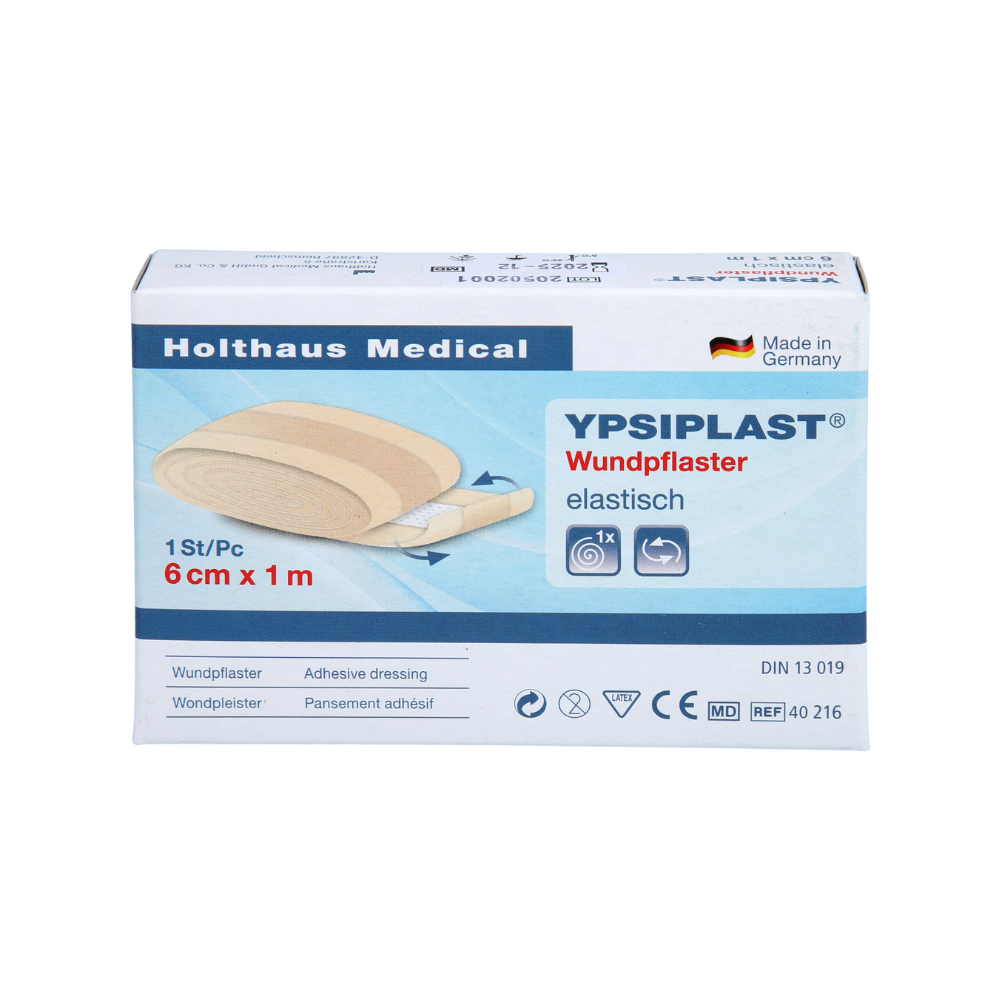 The image shows a pack of Holthaus Ypsiplast® adhesive bandage, elastic - 6 cm x 1 m from Holthaus Medical GmbH & Co. KG. The box contains a single piece of elastic adhesive bandage and indicates that it was made in Germany from breathable fabric. Additionally, several symbols and product specifications can be seen.