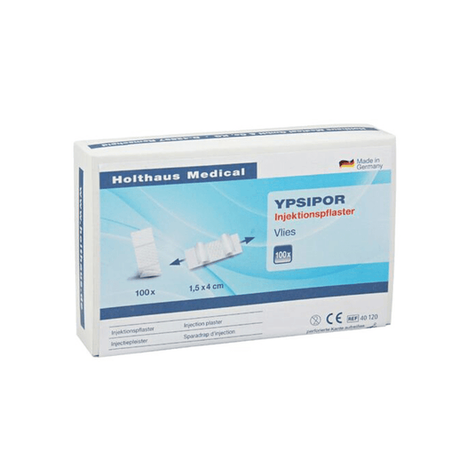 On display is a box of Holthaus Ypsipor injection patches manufactured by Holthaus Medical GmbH & Co. KG. The predominantly white packaging with blue accents contains 100 patches measuring 1.5 x 4 cm. The box features text in German and a picture of the patches.