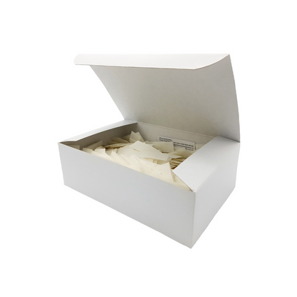 A white, rectangular box with a partially open lid containing numerous small, individually packaged Holthaus Ypsipor injection plasters. The box and packages are plain and unlabelled. The image suggests storage or organization by Holthaus Medical GmbH & Co. KG.