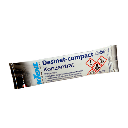 A silver-blue disposable package from Johannes Kiehl KG with the inscription "Kiehl Desinet-compact Concentrate" contains an aldehyde-free liquid disinfectant cleaning concentrate with German text and hazardous substance warnings.