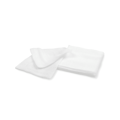 Two white, folded towels on a plain white background. One towel is partially laid over the other, showing their soft texture and similarity to the Meditrade BeeSana® gauze compress in medical facilities of Meditrade GmbH.