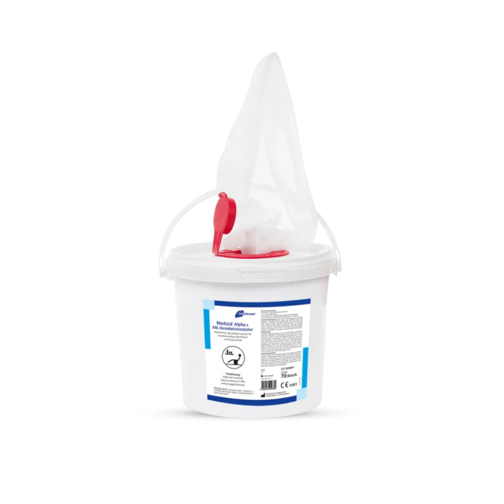 A white industrial bucket from Meditrade GmbH with a red handle and spout, equipped with labels and safety instructions for use in medical facilities. The lid is partially covered with a white cloth or tissue.