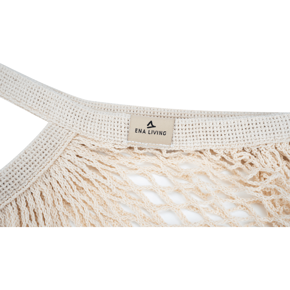 Close-up of a cream-colored ENA Living shopping net from Abena Re-Seller GmbH with sturdy, braided handle and "ENA LIVING" label - perfect for environmentally conscious shopping; available as a box (24 packs).