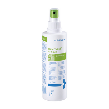 A white spray bottle labeled “Schülke Mikrozid® AF liquid” for disinfection with green-blue text and a green spray nozzle. Symbols and text indicate medical use.