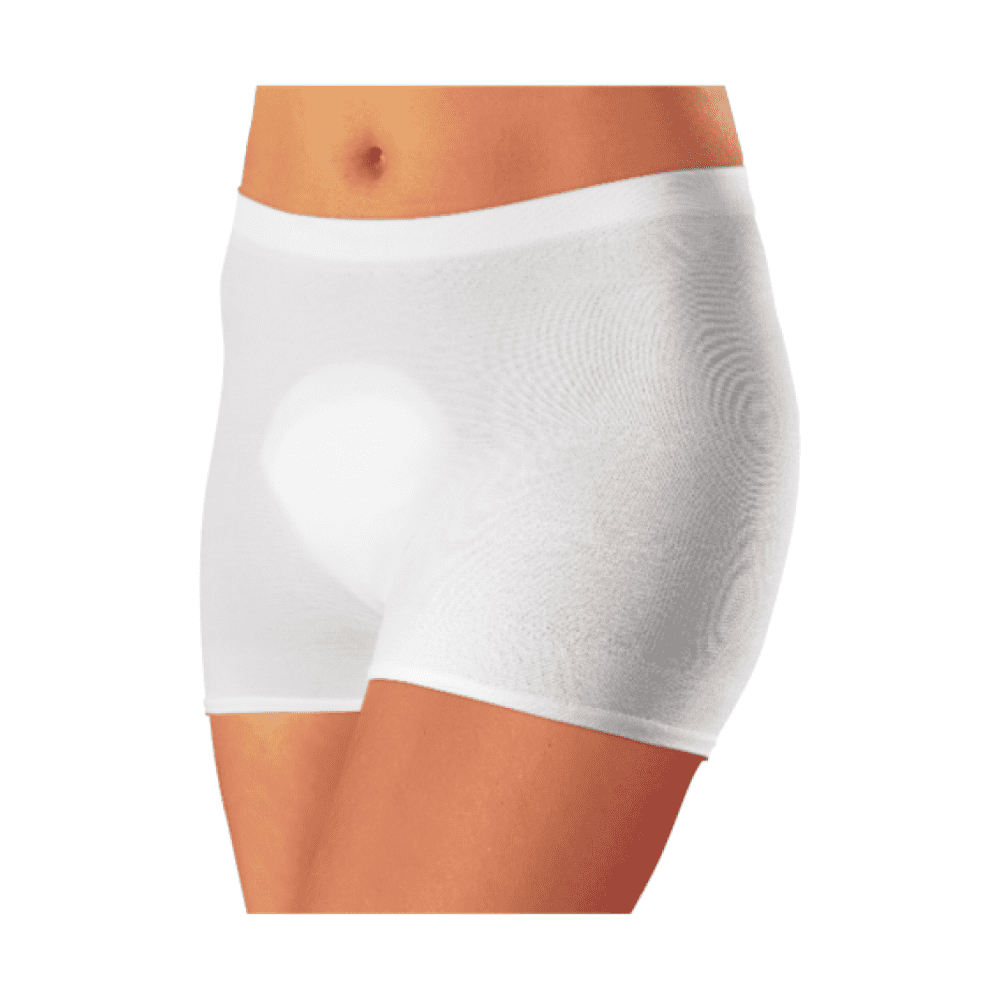 A close-up of a person wearing white, form-fitting boxer shorts "Seni Fix Comfort elastic fixation pants" by TZMO Deutschland GmbH, focusing on the area from the waist to the mid-thigh against a white background.