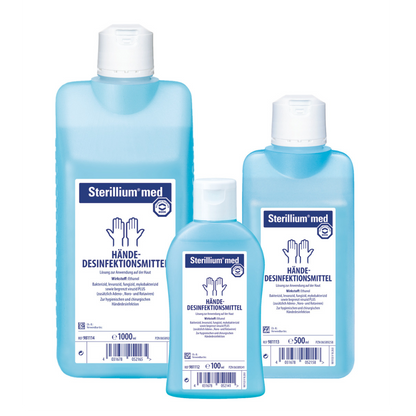 Three bottles of Sterillium® med hand disinfectant based on ethanol in different sizes with German labeling. The bottles are translucent blue with white caps and labels with medical symbols. The product is manufactured by Paul Hartmann AG.