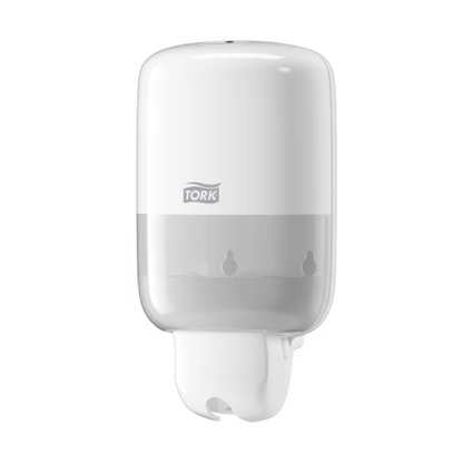 The Tork 561000 Mini Dispenser from TORK - Essity Professional Hygiene Germany GmbH is an elegant, white wall-mounted dispenser for liquid soap from the Elevation S2 series. The striking "Tork" branding emphasizes its modern aesthetics and combines functionality with stylish design.