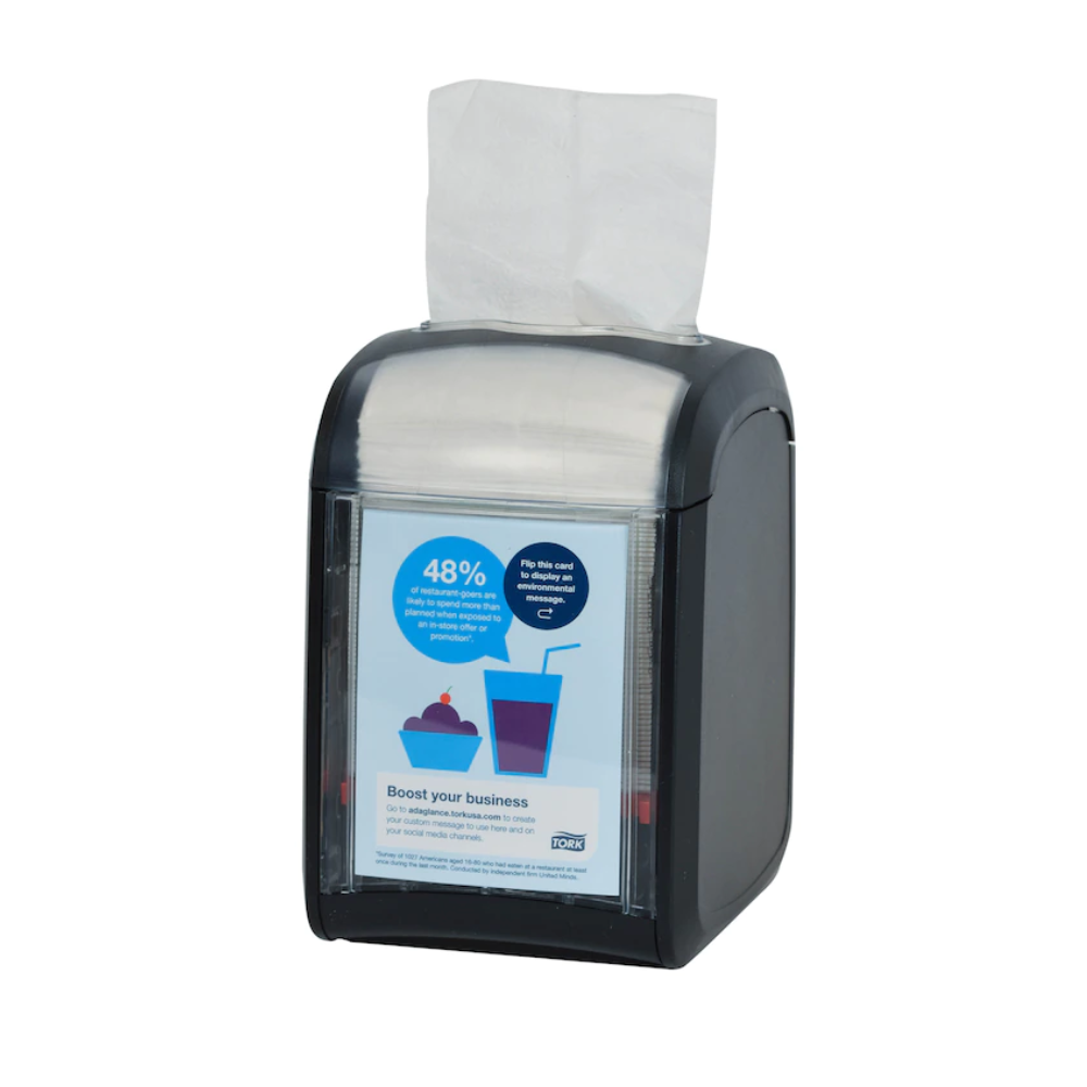 The Tork Xpressnap Fit® 272900 table dispenser for napkins by TORK - Essity Professional Hygiene Germany GmbH is a stylish napkin dispenser made of black plastic with a transparent front that displays marketing materials. With a partially visible stack of white napkins, it is designed for efficient napkin use and is therefore ideal for any setting.