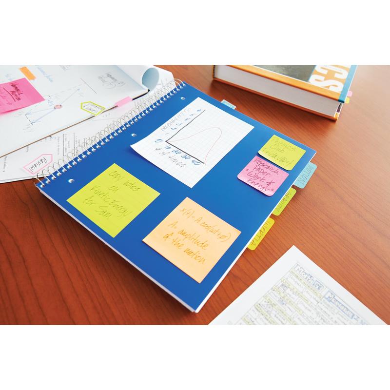 A blue spiral notebook with Post-it® Notes from 3M Deutschland GmbH in various neon colors (38x51 mm, 100 sheets/pad, 3 pads/pack) lies on a wooden table, next to papers and a school book.