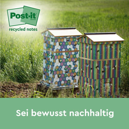 Two colorful beehives with hexagonal patterns stand in a meadow in the sunlight. In the corner appears the logo of Post-it® Super Sticky 100% Recycled Notes by 3M Deutschland GmbH. The text below reads: "Be consciously sustainable.