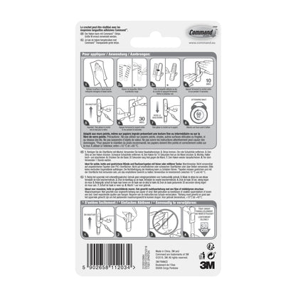 Auf der Rückseite des Mittelgroße Command™ Mehrzweckhaken M Vorteilspack (17001-2) von 3M Deutschland GmbH befinden sich bebilderte Montageschritte, mehrsprachige Warnhinweise, ein Barcode, Herstellerinformationen und das 3M Logo unten rechts.