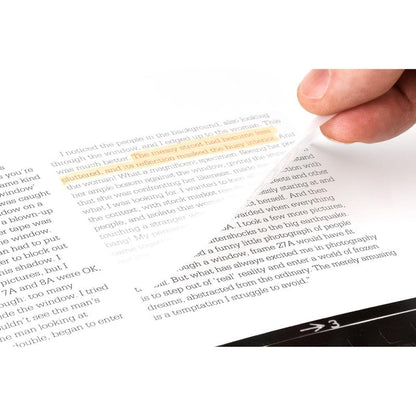 A hand lifts a transparent 3M Post-it® Note (73 mm x 73 mm, 36 sheets/block, 12 blocks/package) from a book page, showing the highlighted text while the printed text underneath remains visible.