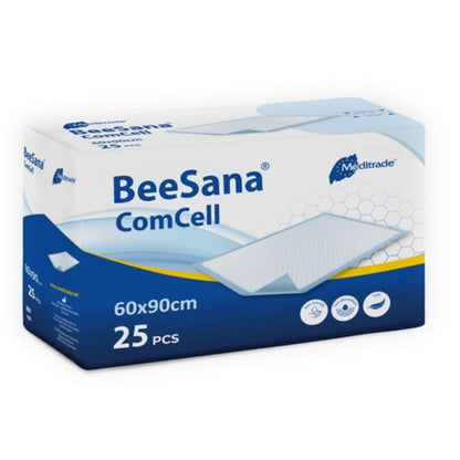 The image shows a rectangular packaging of the BeeSana® ComCell pad by Meditrade GmbH. The white-blue box measures 60x90 cm, contains 25 pieces, and is made of highly absorbent cellulose paper.